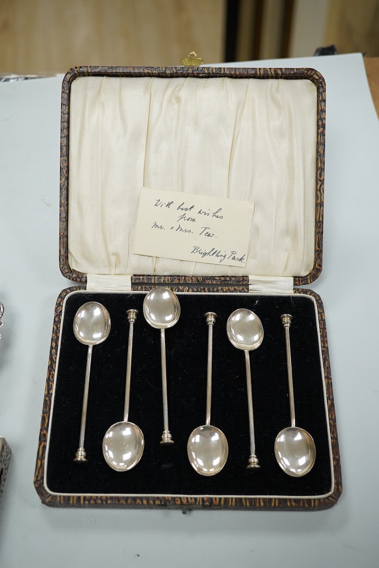 A collection silver and white metal to include a cased set of six George V seal top coffee spoons, Birmingham, 1927, a pair of Scottish napkin rings embossed with thistles, a pair of embossed heart shaped bonbon dishes,